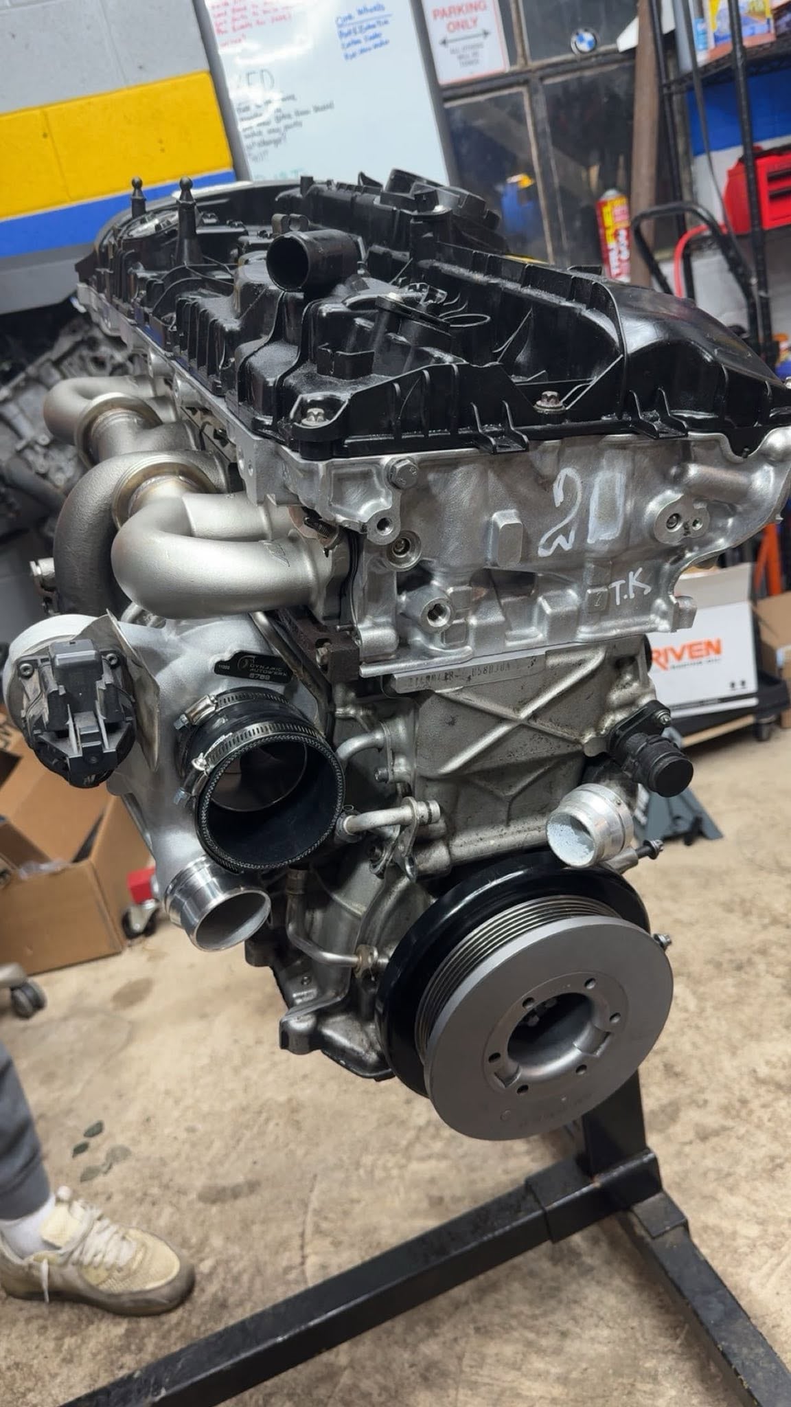 Complete engine mounted vertically on a red engine stand